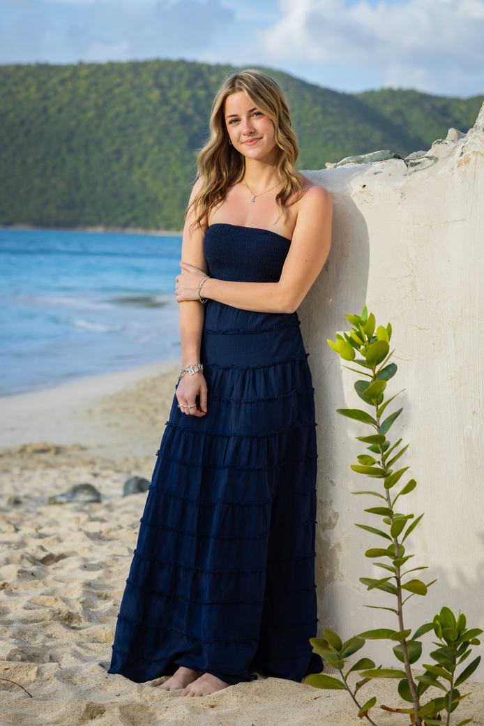 Senior portrait against a weathered island wall