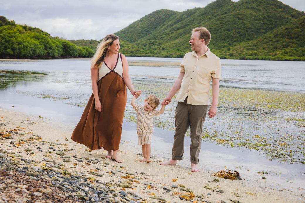 Young family walking the shoreline together